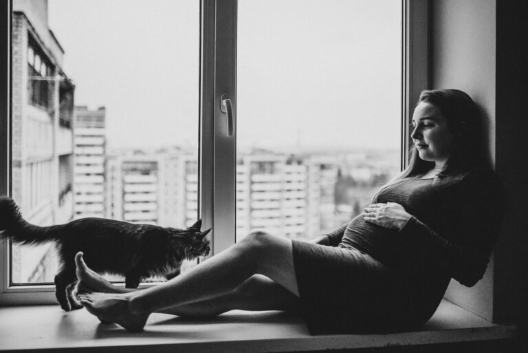 Вагітна жінка на підвіконні